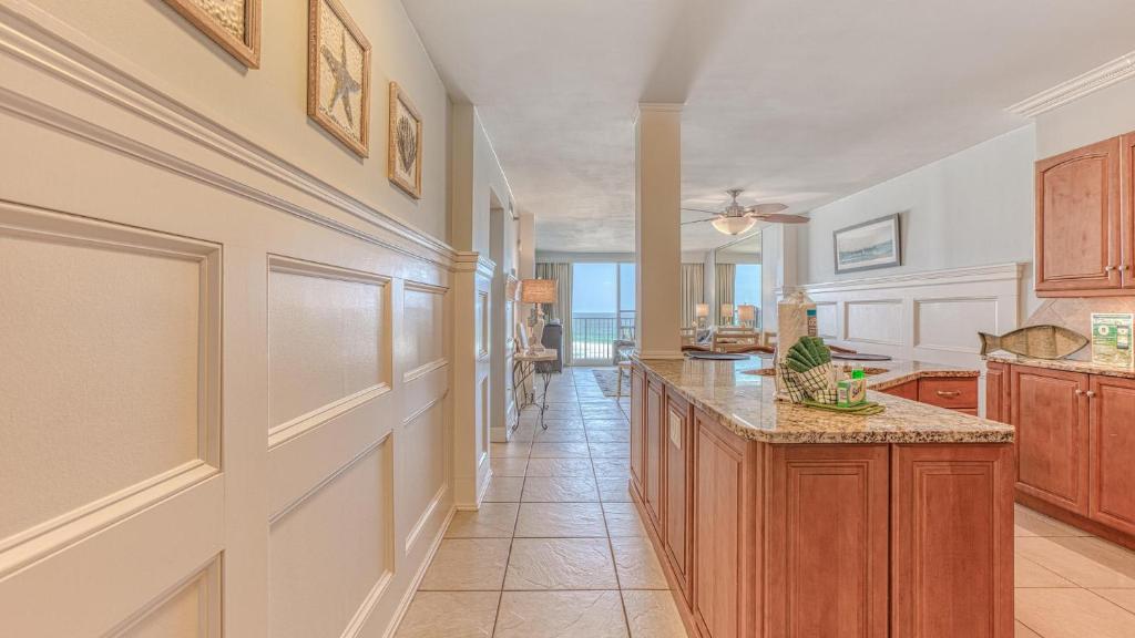 a kitchen with wooden cabinets and a large island at Destin on the Gulf 703 - Gulf Front Property 7th Floor in Destin