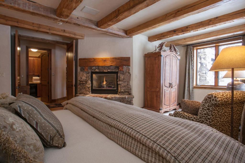 a bedroom with a bed and a fireplace at 866 Bachelor Ridge in Edwards