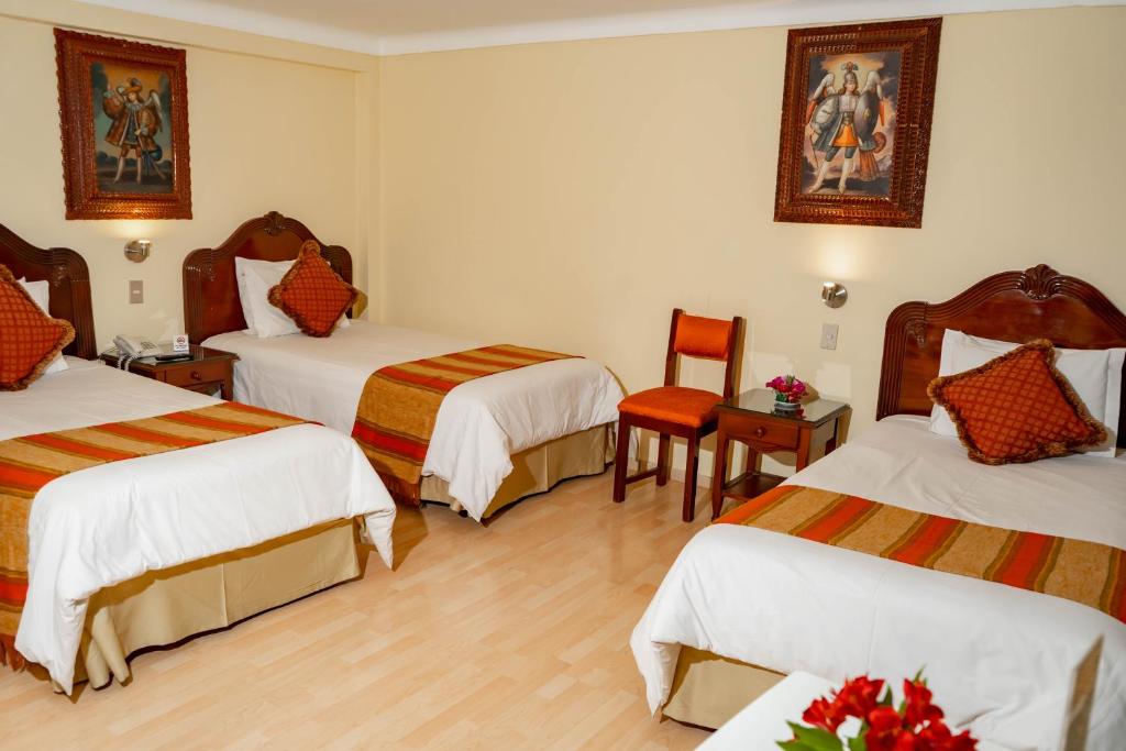 Rúm í herbergi á Hotel Agustos Cusco
