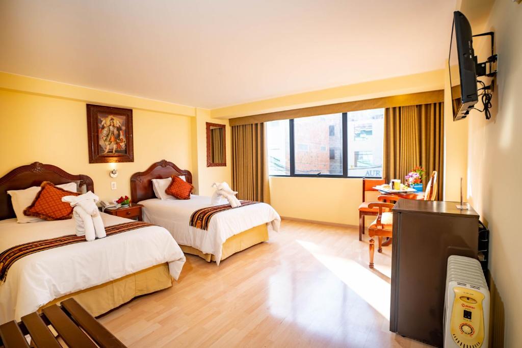 Rúm í herbergi á Hotel Agustos Cusco