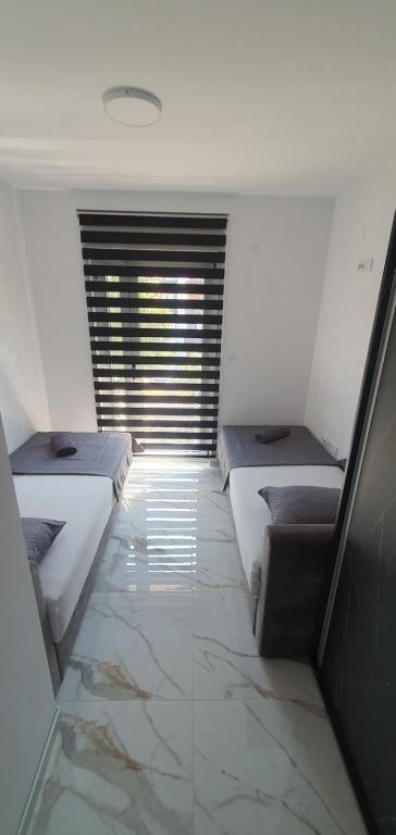 Postel nebo postele na pokoji v ubytování ITACA apartman Krupanj