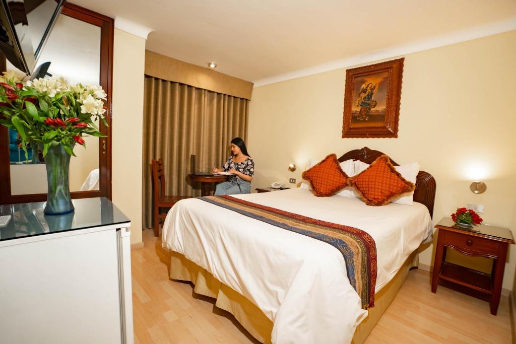 Rúm í herbergi á Hotel Agustos Cusco