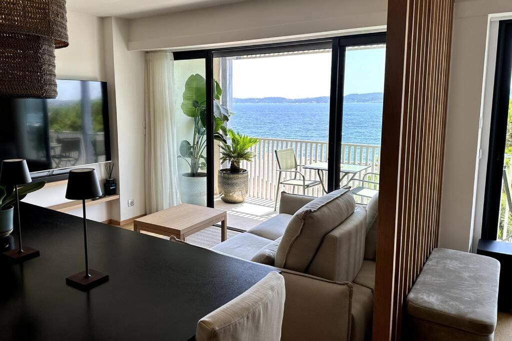 a living room with a view of the ocean at Suite de luxe avec vue mer in Sainte-Maxime