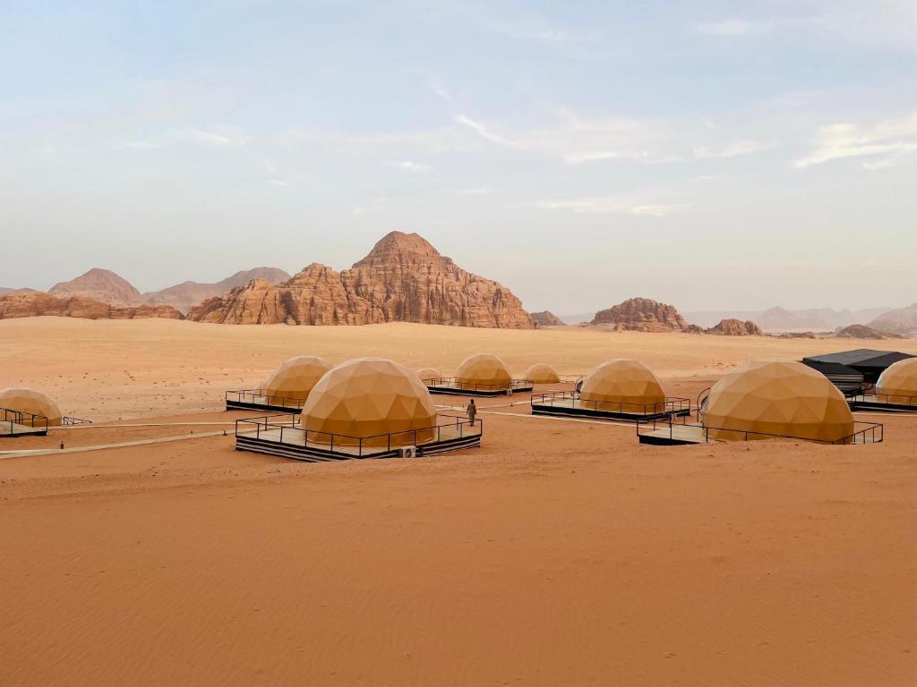 a group of five domes in the desert at Daniela Camp Wadi Rum in Wadi Rum