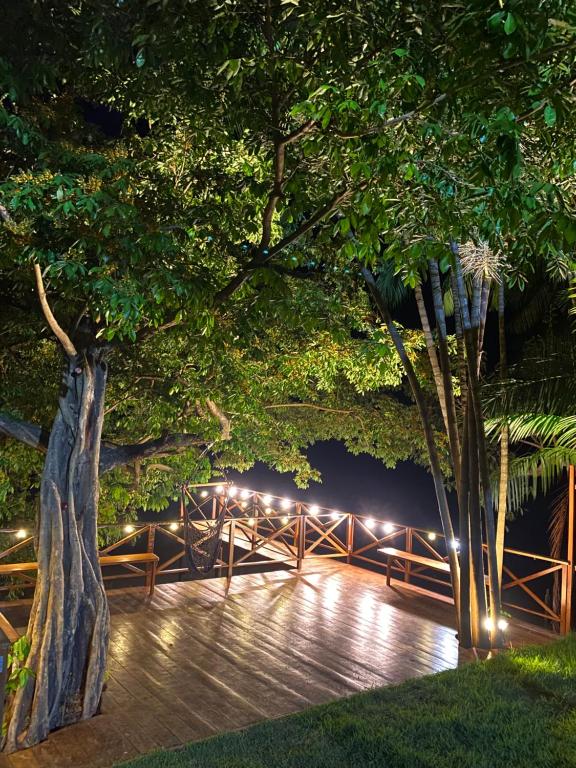 a wooden boardwalk with lights on it at night at Pousada Casa Dunas in Barreirinhas