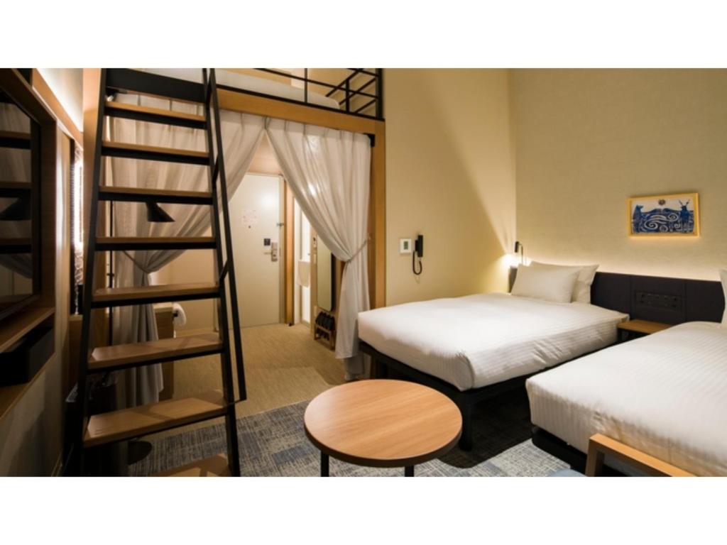 a hotel room with two beds and a ladder at GRIDS Premium Hotel Otaru - Vacation STAY 68545v in Otaru