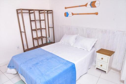 a bedroom with a bed and a nightstand with a ladder at Apartamento Econômico na Gilka Machado in Rio de Janeiro