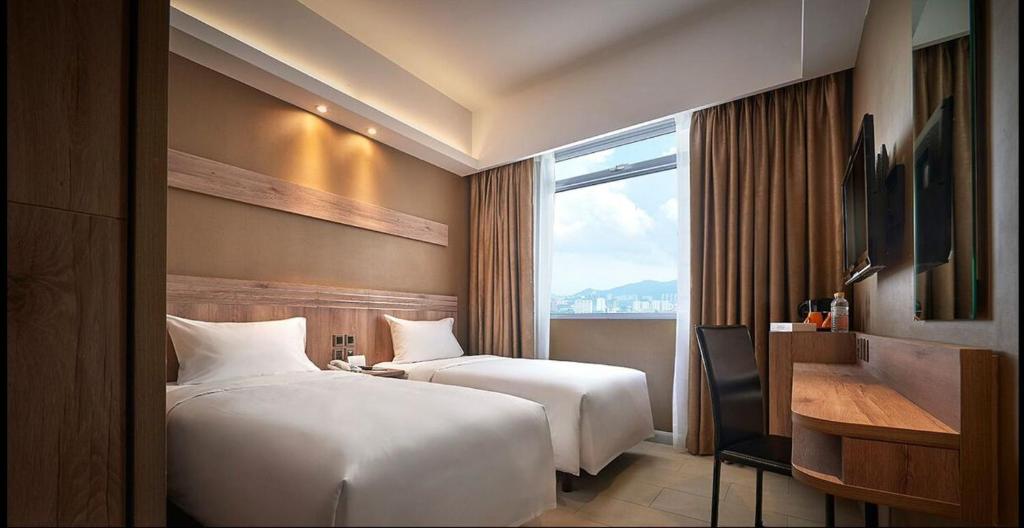 A bed or beds in a room at Cititel Express Penang