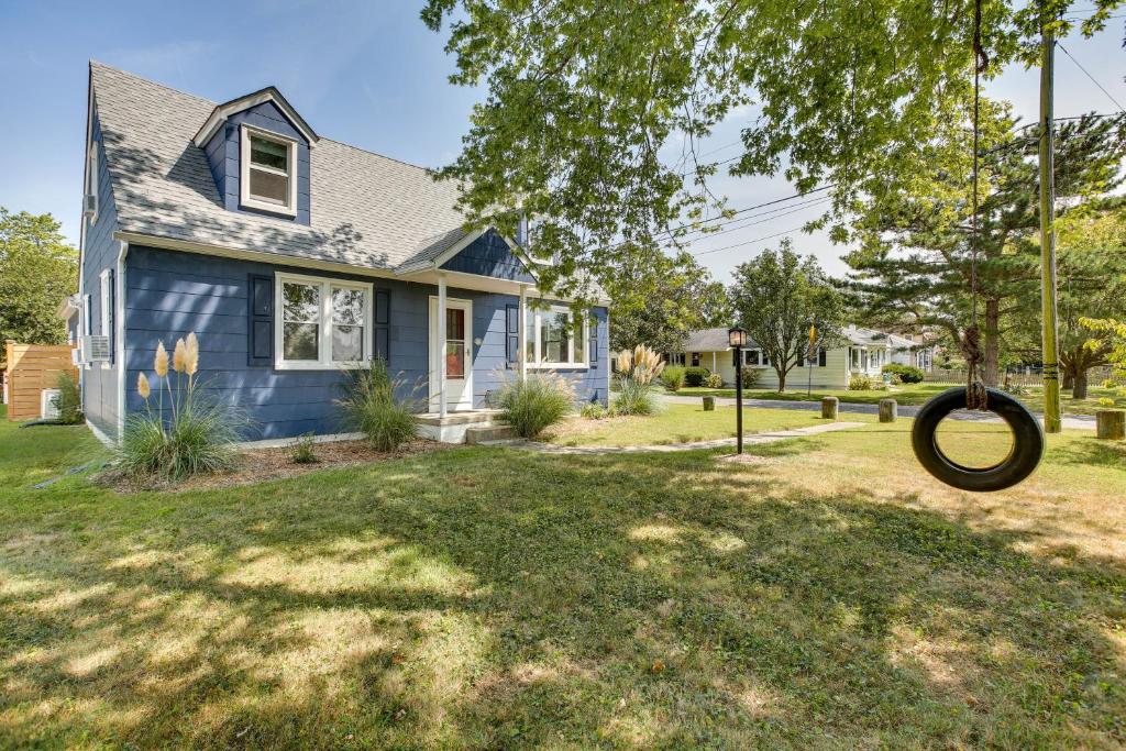 a blue house with a tire in the yard at Cape May Vacation Rental about 3 Mi to Beach and Mall! in Cape May