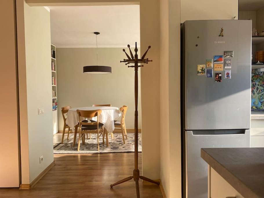een keuken met een tafel en een koelkast bij Apartments in Valmiera in Valmiera