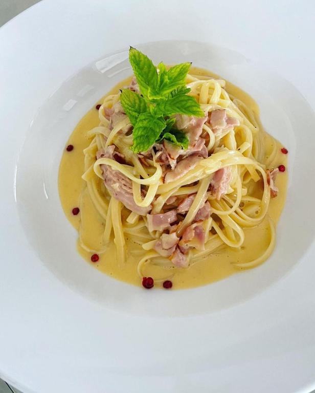 a white plate of pasta with meat and sauce at Blue Paradise Hotel in Orikum