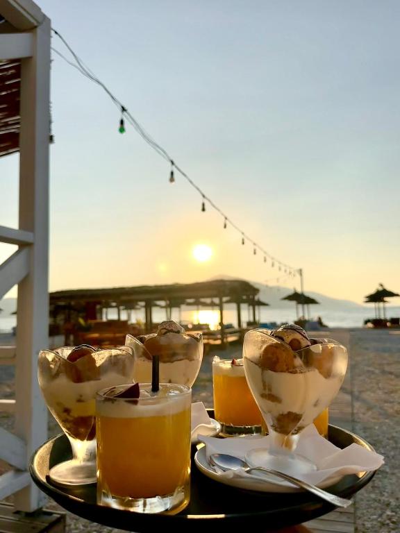 a tray of drinks on a table near the beach at Blue Paradise Hotel in Orikum