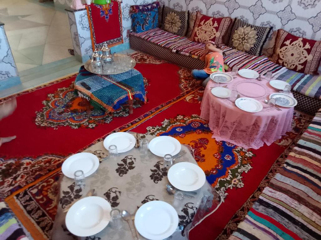 a room with a table with plates and dishes on it at Dar Brahim tizgui nbarda in Ouarzazate