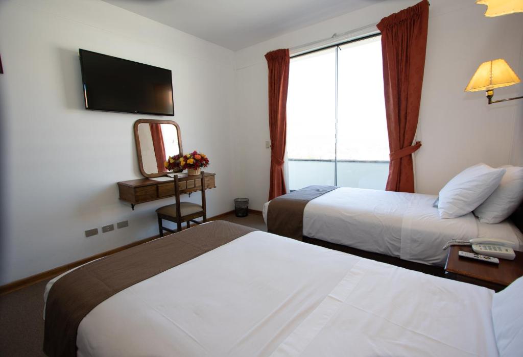 Postel nebo postele na pokoji v ubytování DM Hoteles Cusco