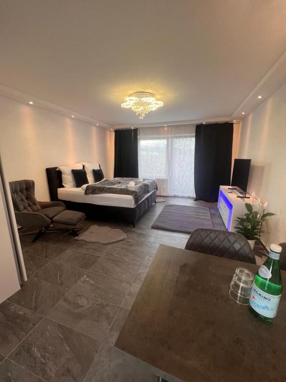 a living room with a bed and a couch at LUX Business Apartments in Weil am Rhein