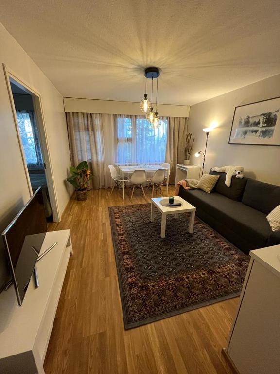 a living room with a couch and a table at APt 37 in Rovaniemi
