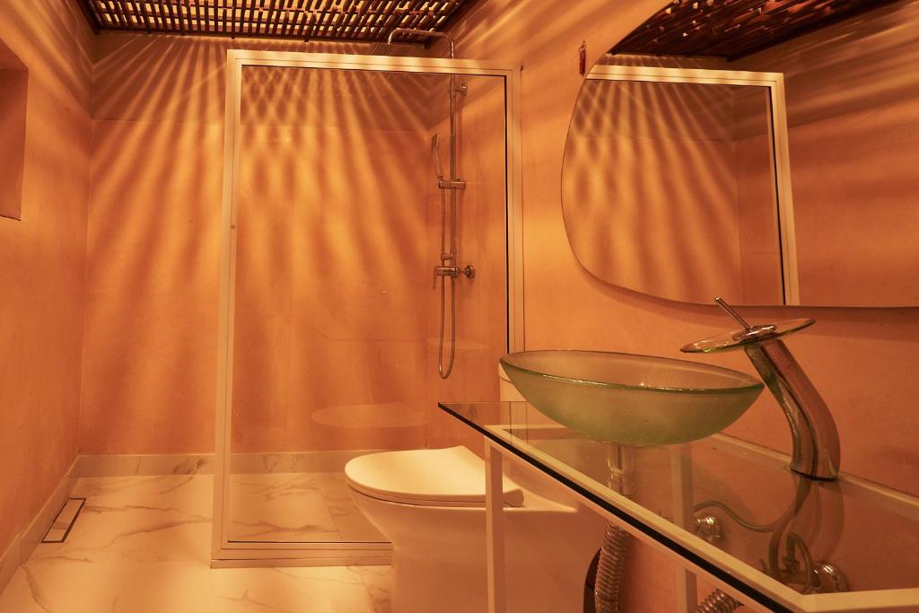 a bathroom with a bowl sink and a toilet at DUO BOUTIQUE HOTEL in Medellín