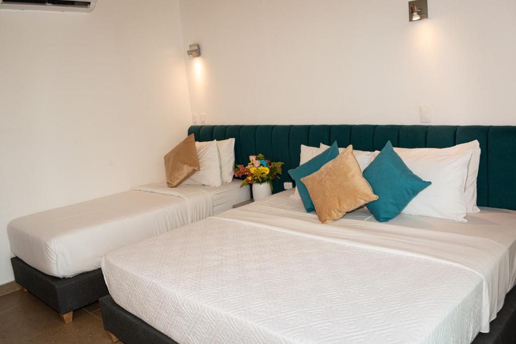 Postel nebo postele na pokoji v ubytování Hotel Caribbean Cartagena