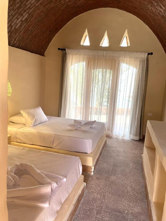 Postel nebo postele na pokoji v ubytování Ayujidda Nubian House