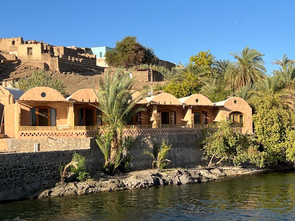 a house on the banks of a body of water at Ayujidda Nubian House in Aswan