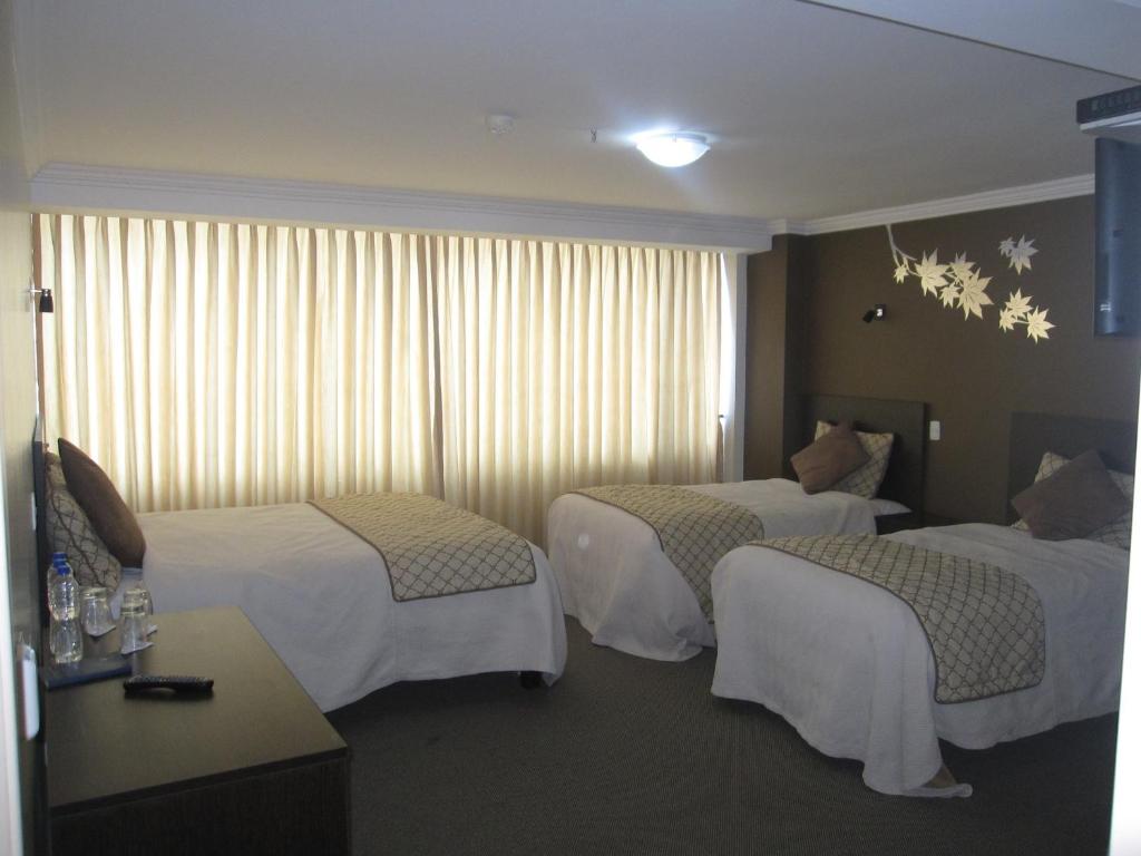 Postel nebo postele na pokoji v ubytování Hotel Novalux