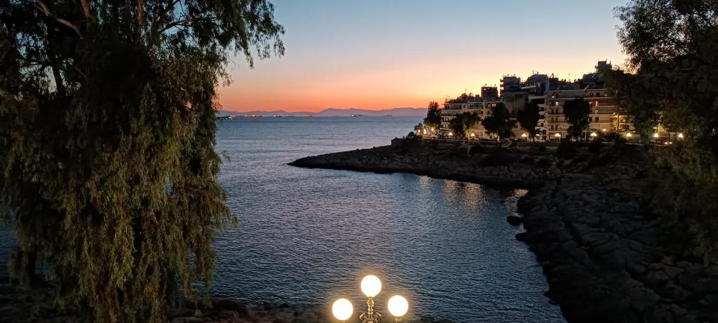 a view of a body of water at sunset at By the oceam luxury studios in Piraeus