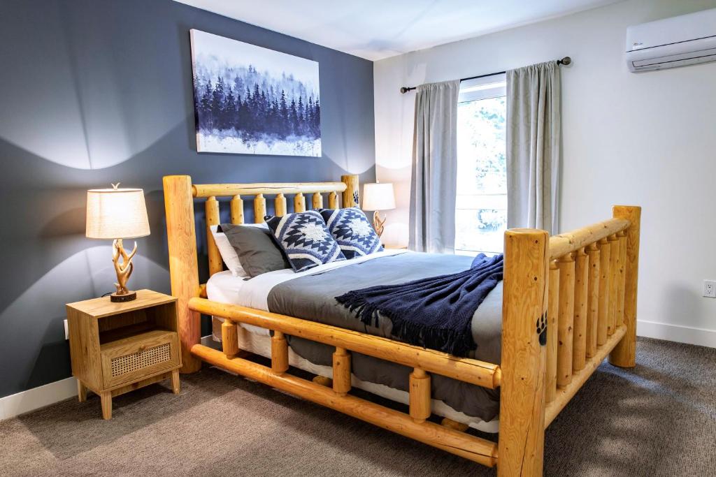 a bedroom with a wooden bed and a window at The Revy Dream in Revelstoke