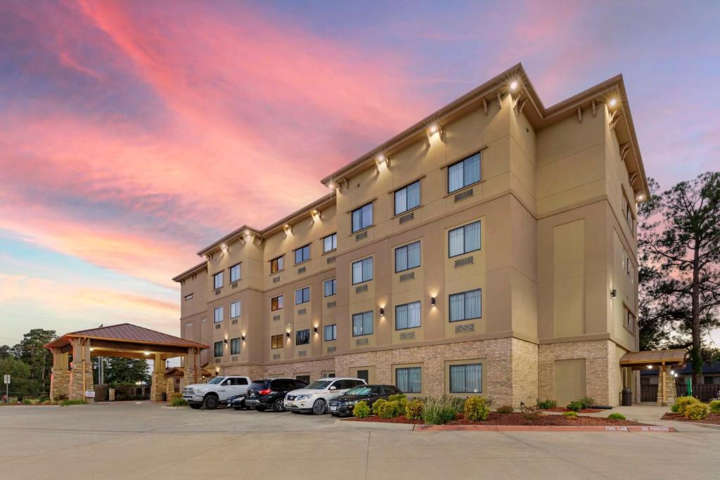 una representación de un hotel con coches estacionados en un estacionamiento en Best Western Plus Classic Inn and Suites, en Center