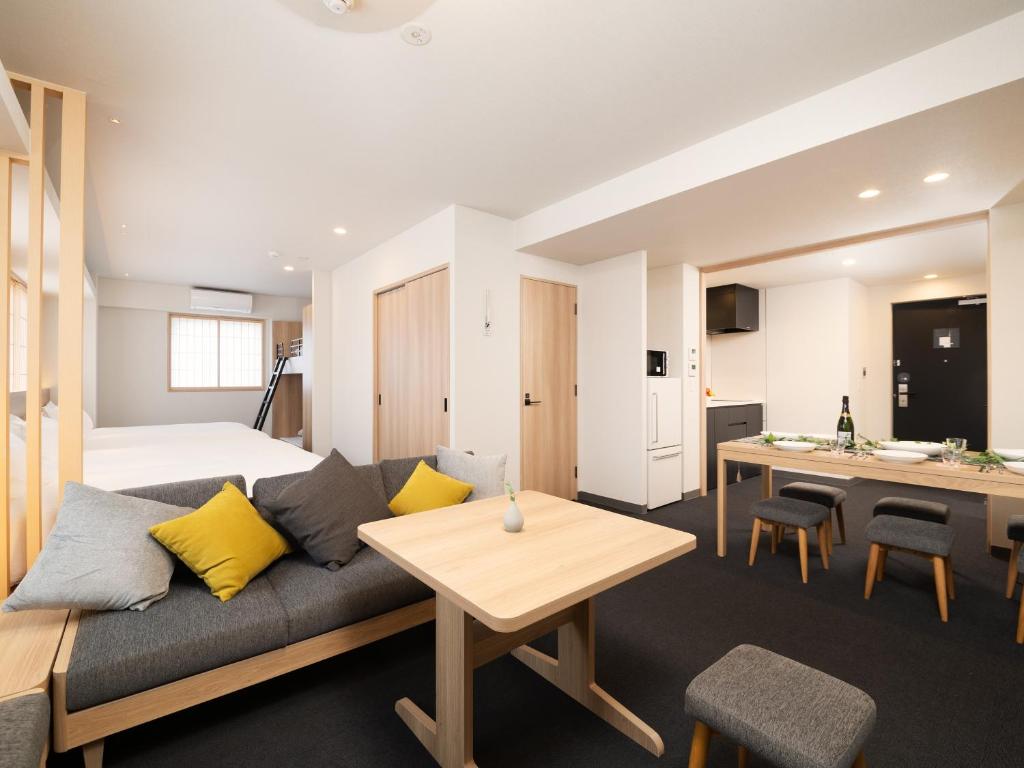 a living room with a couch and a table at MIMARU Tokyo Hatchobori in Tokyo