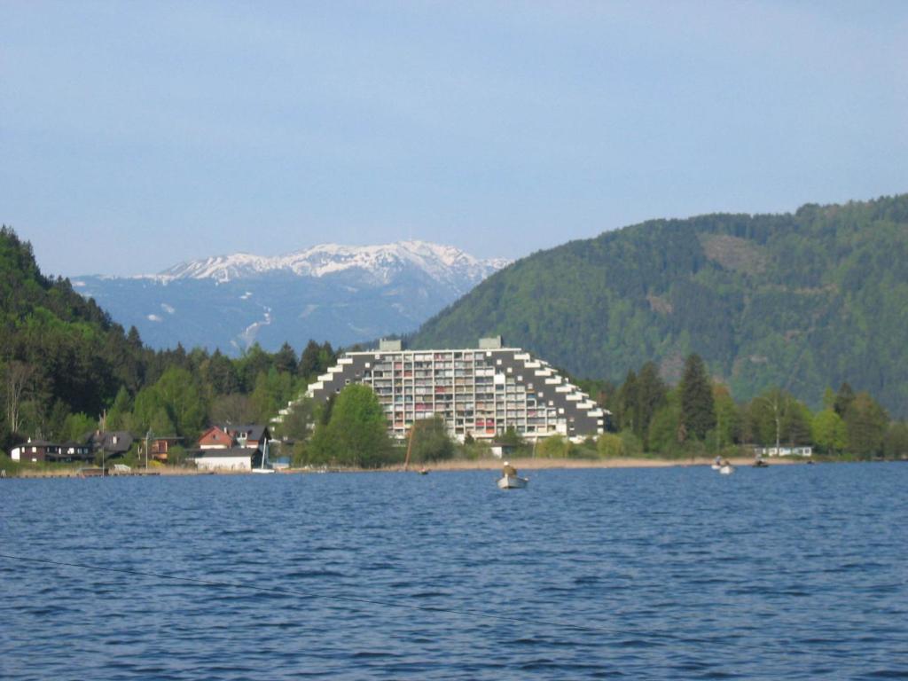 a large building in the middle of a lake at Ferienwohnung im Haus Landskron in Landskron