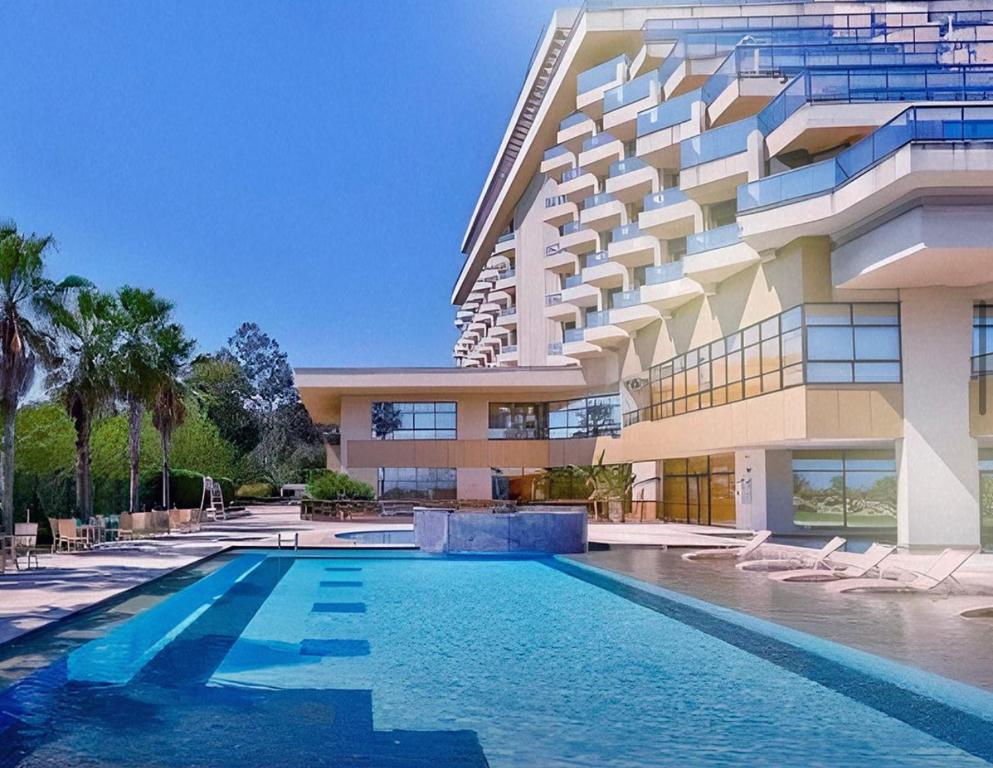 a building with a swimming pool in front of a building at Apartamento Vista.Rio in Niterói