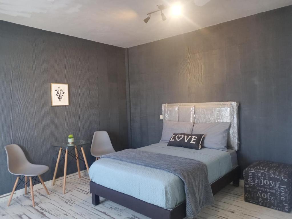 a bedroom with a bed with a love pillow on it at Ramona loft in Villahermosa
