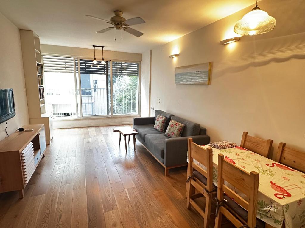 a living room with a couch and a table at Family Park apartment with 2 bedrooms in Tel Aviv