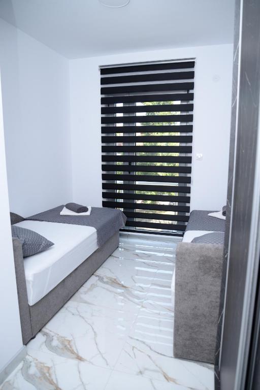Postel nebo postele na pokoji v ubytování ITACA apartman Krupanj