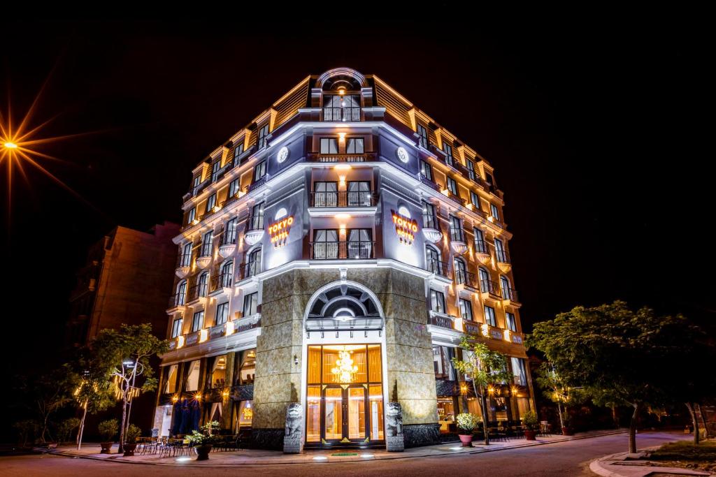 a tall building with lights on it at night at Tokyo Hotel Phan Rang in Thôn Mỹ Phước