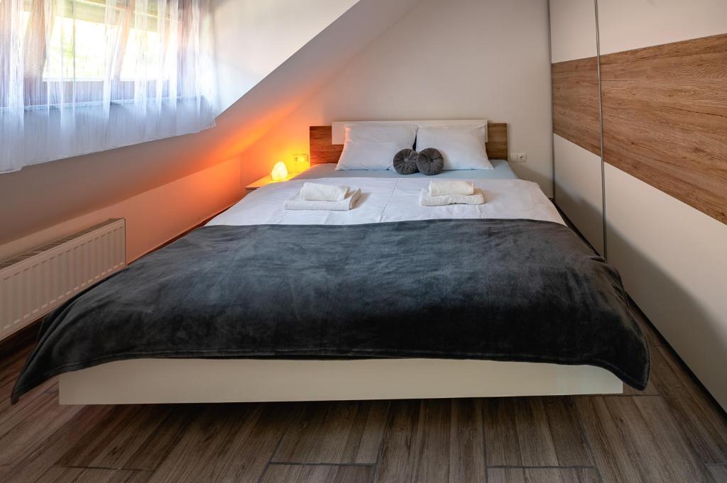 a bedroom with a large bed in a room at Apartmaji Pr' Kopavank in Rateče