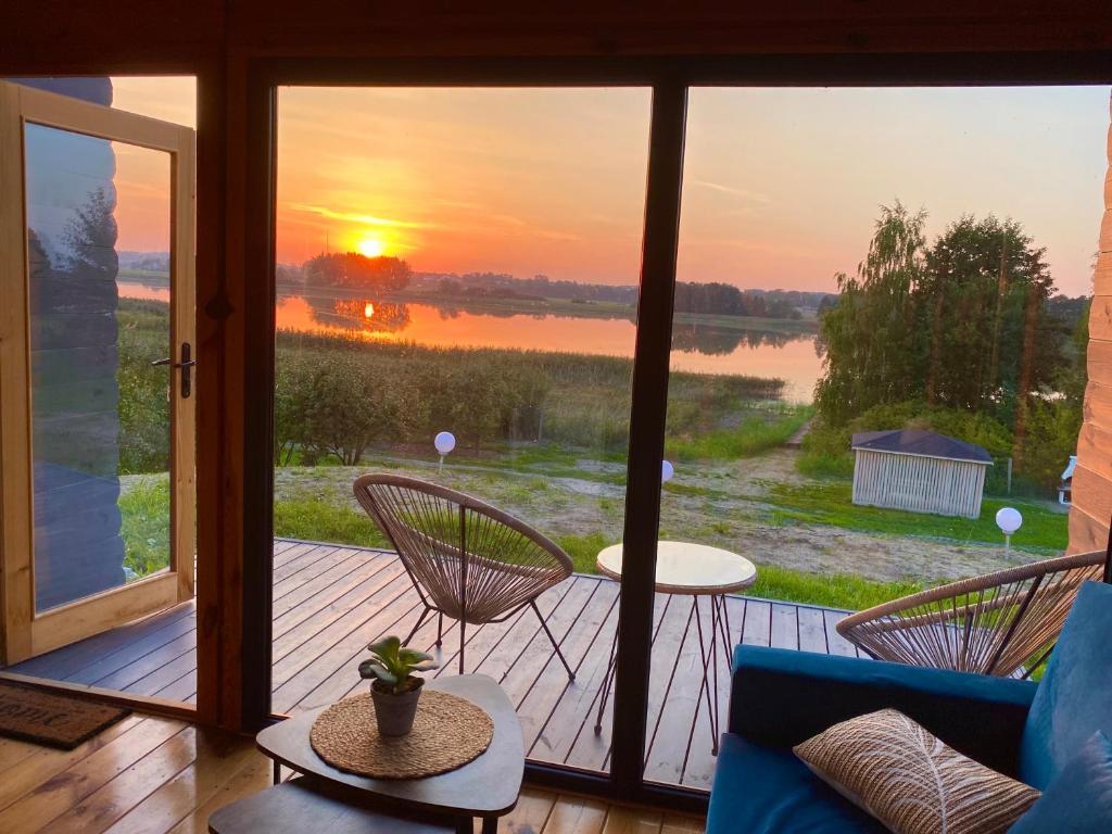 a screened in porch with a view of a sunset at Spokojny zakątek in Silice