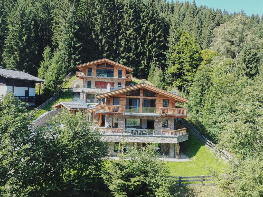 an aerial view of a large house in the woods at Chalet Glemmerl Mountain Lodge Saalbach Hinterglemm in Saalbach-Hinterglemm