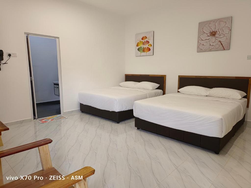 Ένα ή περισσότερα κρεβάτια σε δωμάτιο στο ASM Roomstay-4-2 Queen Beds