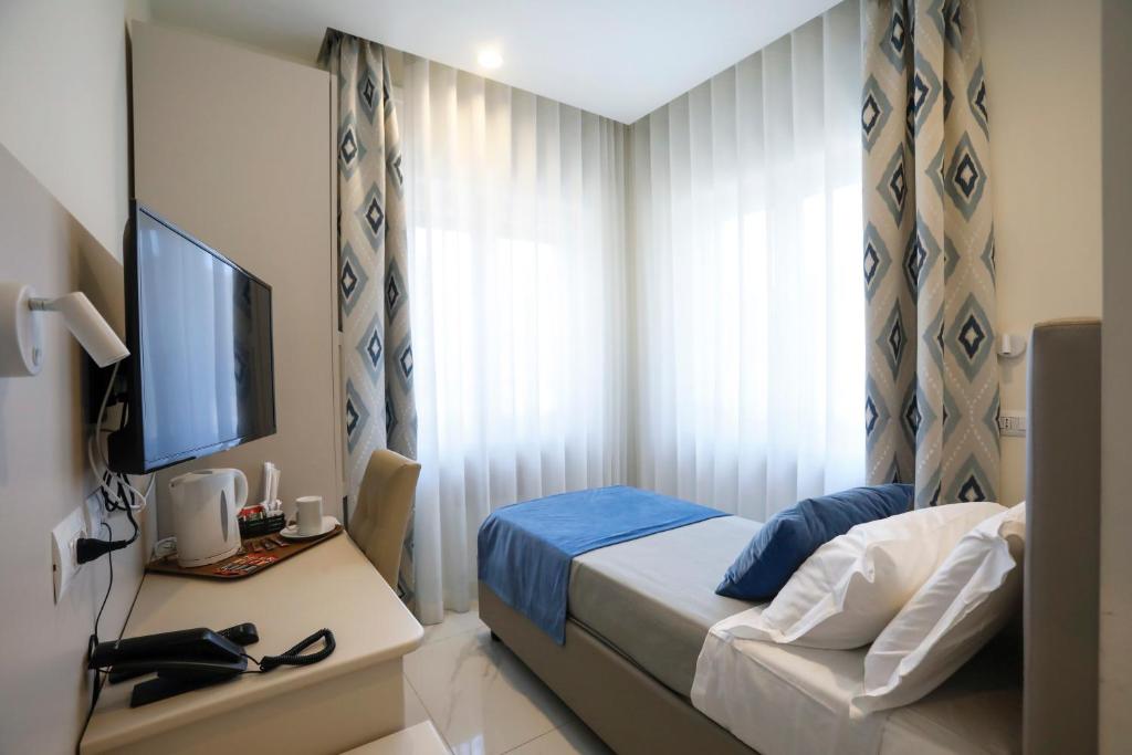 Posteľ alebo postele v izbe v ubytovaní Vomero High Hotel