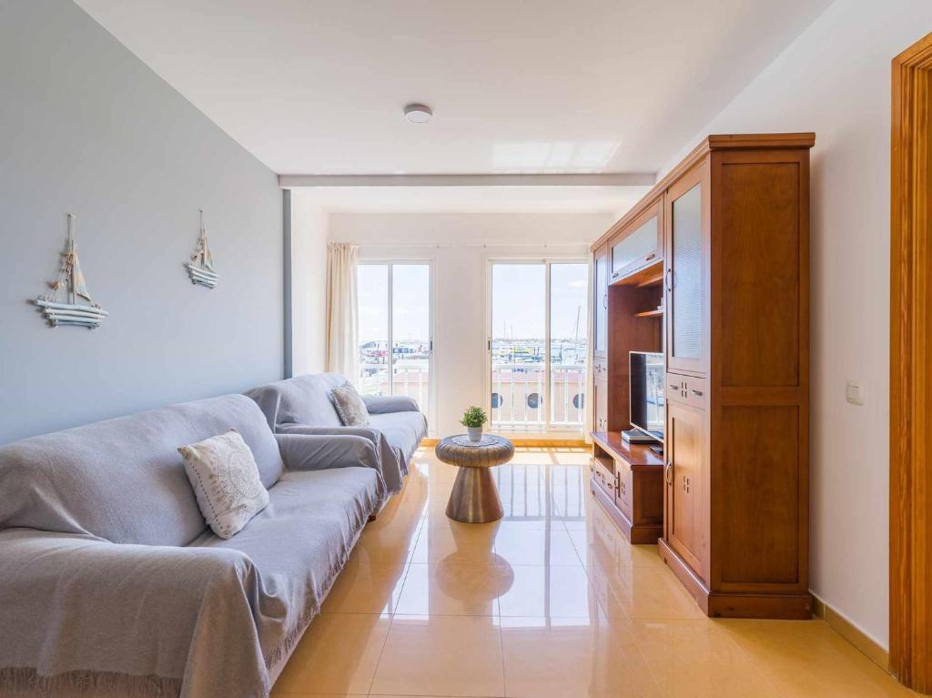 a living room with a couch and a television at Mahostly Corralejo Vista Mar in Corralejo