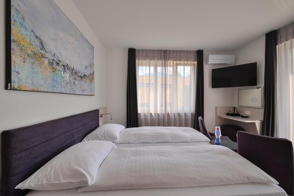 Postel nebo postele na pokoji v ubytování Hotel Luna Garni