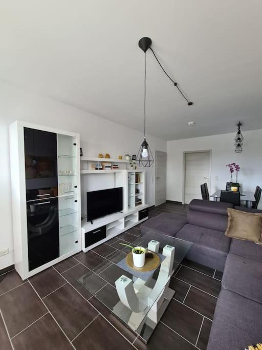 a living room with a couch and a table at Gästewohnung KL. WZL 38_3 in Klein Wanzleben