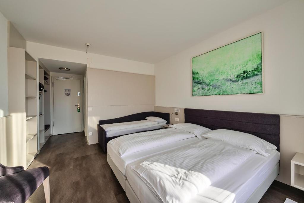 Postel nebo postele na pokoji v ubytování Hotel Luna Garni