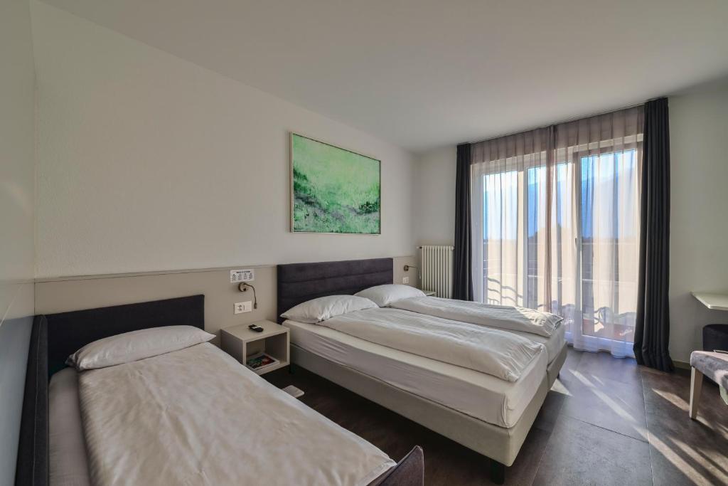 Postel nebo postele na pokoji v ubytování Hotel Luna Garni