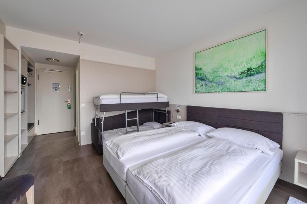 Postel nebo postele na pokoji v ubytování Hotel Luna Garni
