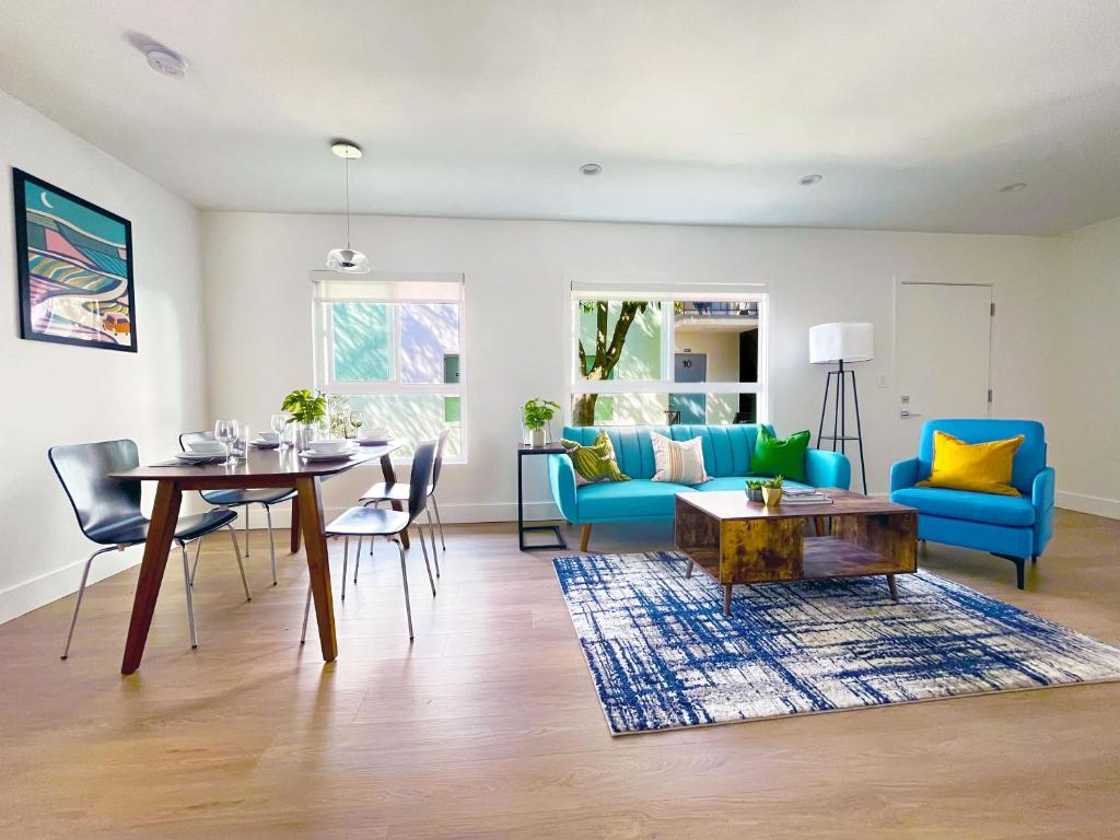 a living room with a blue couch and a table at Hollywood/Thai Town Courtyard Apartment in Los Angeles