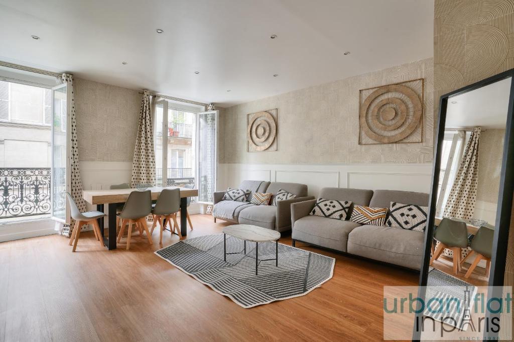 un salon avec un canapé et une table dans l'établissement 23 - Charming 3BDR Parisian Apartment in Montorgueil, à Paris