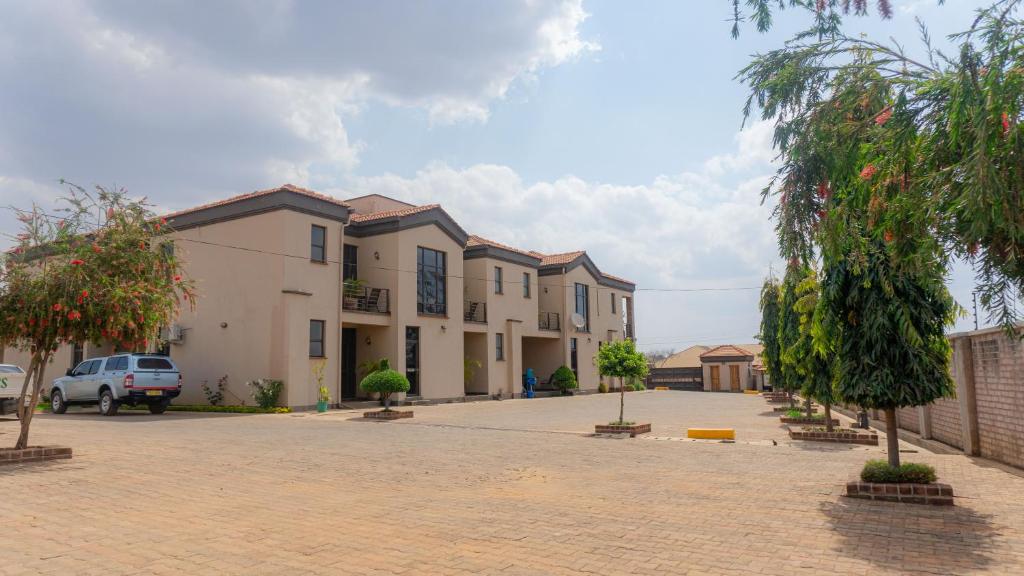 a row of houses in a parking lot at Legacy Suites in Lilongwe