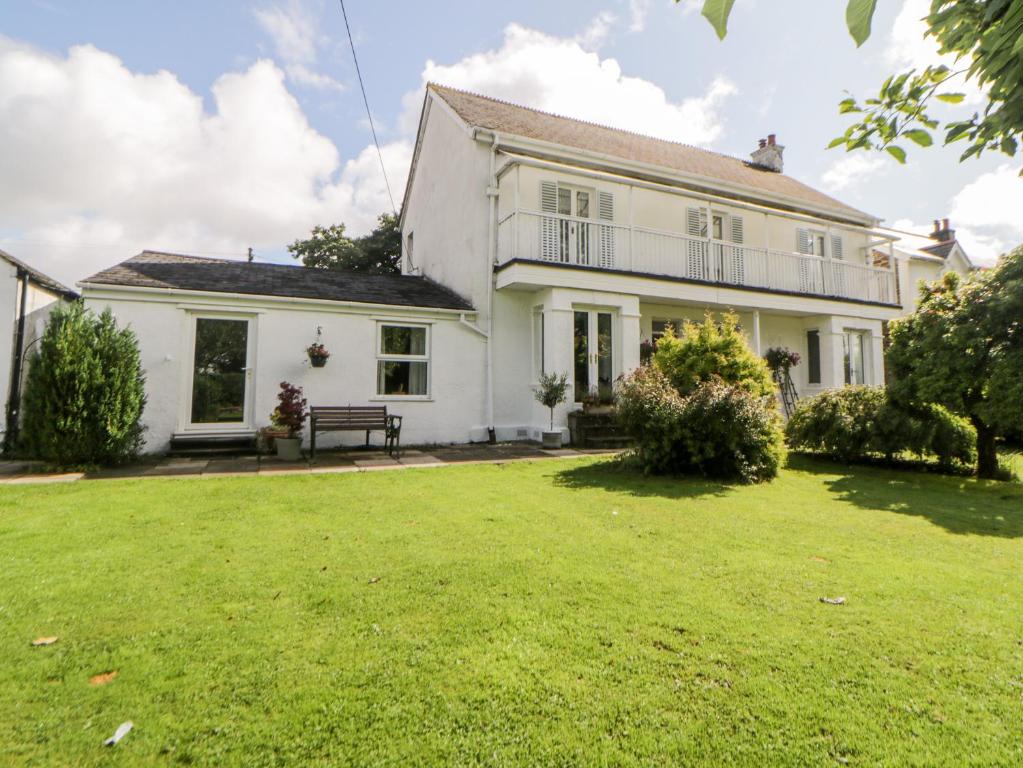 a large white house with a large yard at Little Claremont in Yelverton